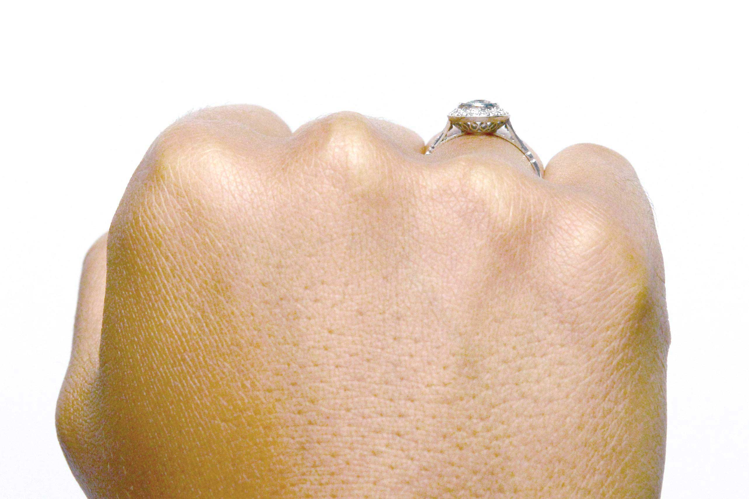 A bezel set diamond is in this engagement ring.
