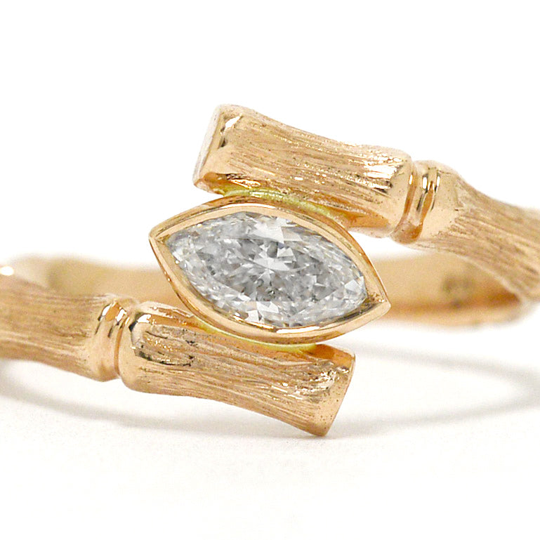 A bamboo marquise diamond solitaire engagement ring.