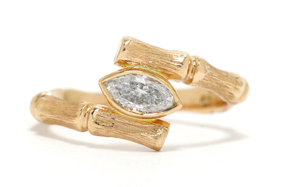 A bamboo marquise diamond solitaire engagement ring.