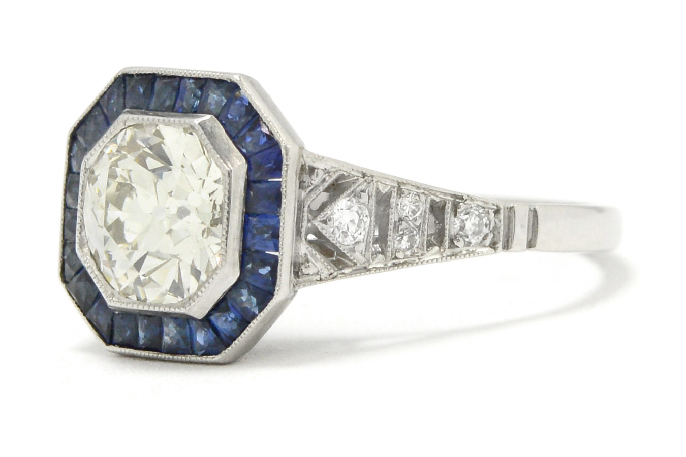 An octagon diamond and blue sapphires target engagement ring.