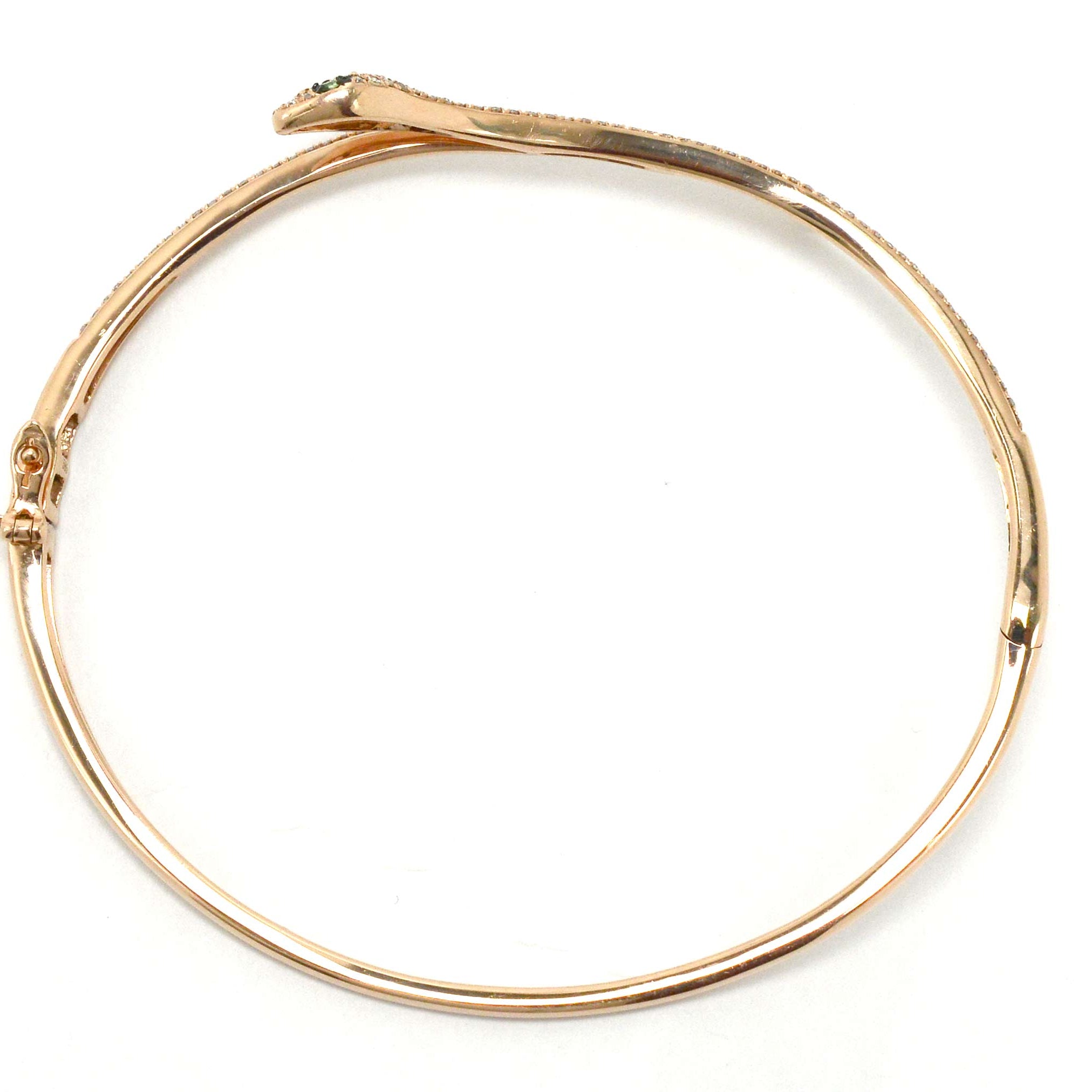 A hinged cuff gold snake bracelet.