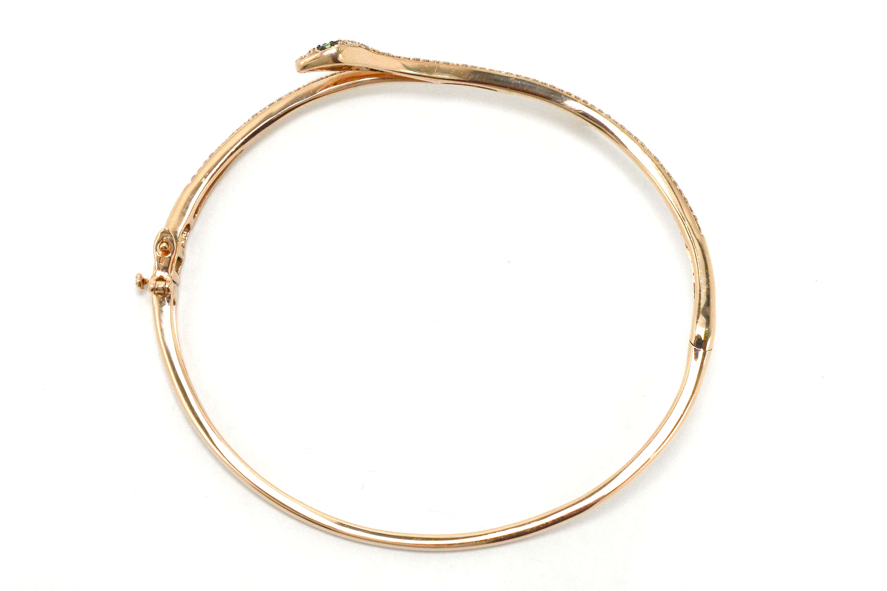 A hinged cuff gold snake bracelet.