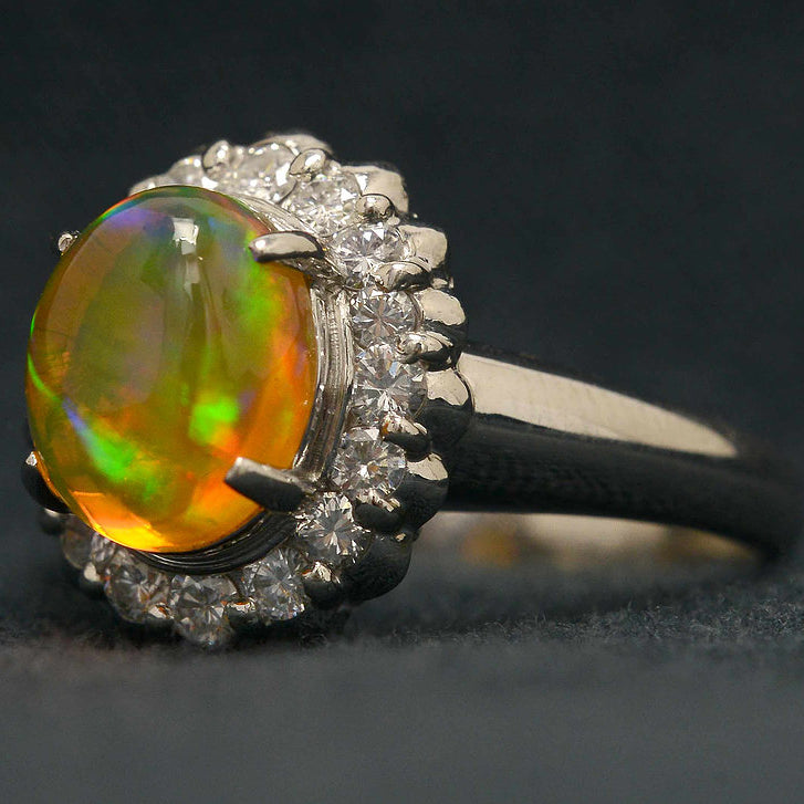 A 2 carat cabochon cut opal platinum engagement ring with a high dome.