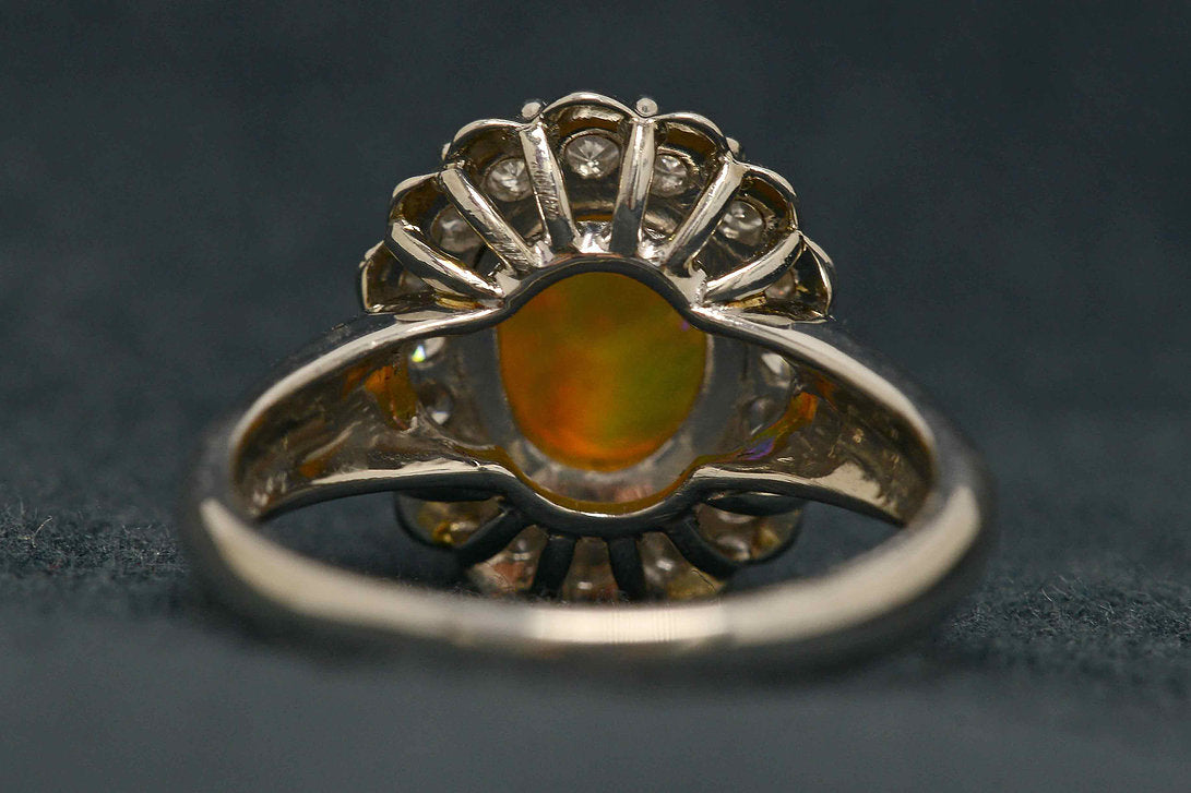 An Australian crystal jelly opal set in a platinum ring with diamonds.