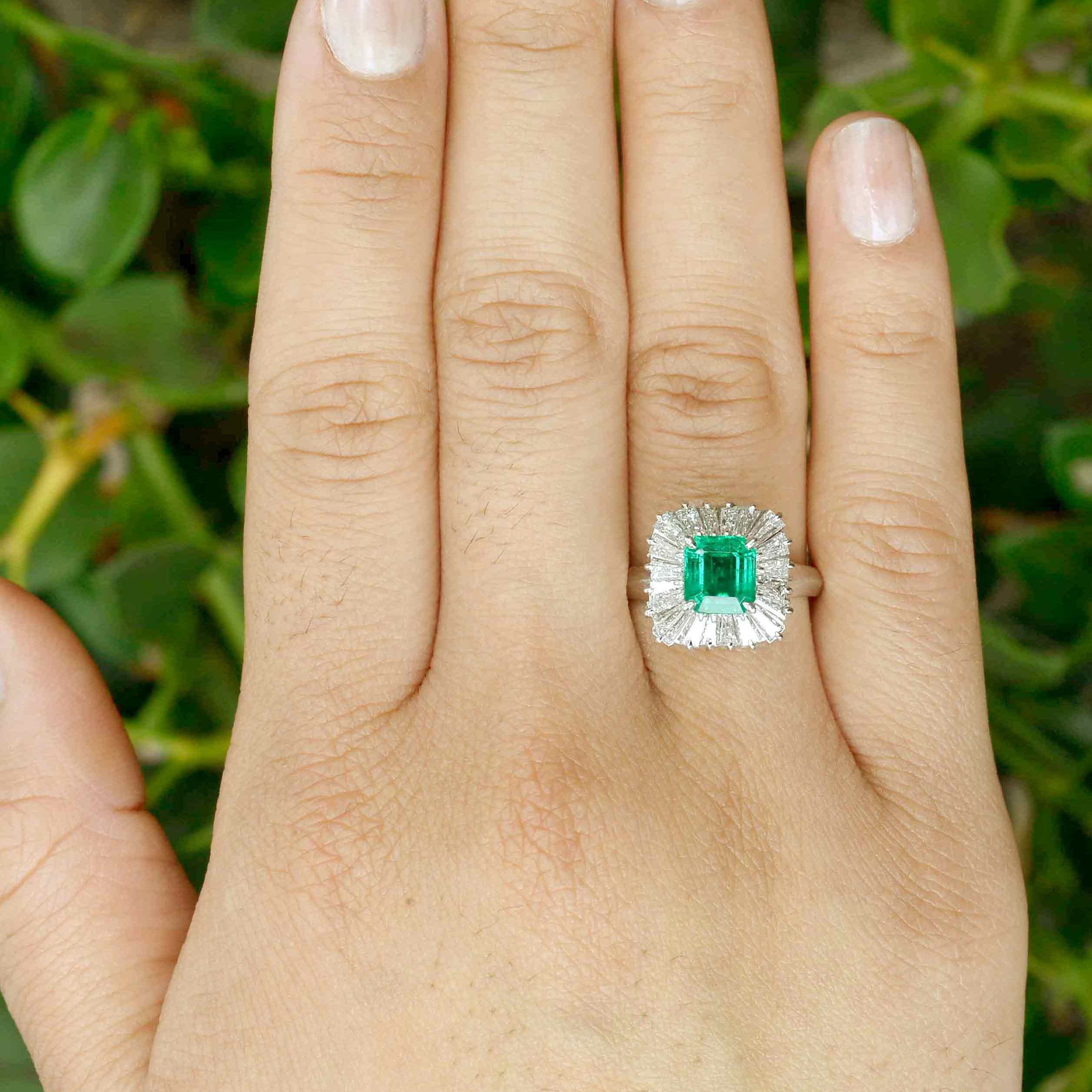 A square shape natural baguette diamonds halo and emerald platinum ballerina ring.