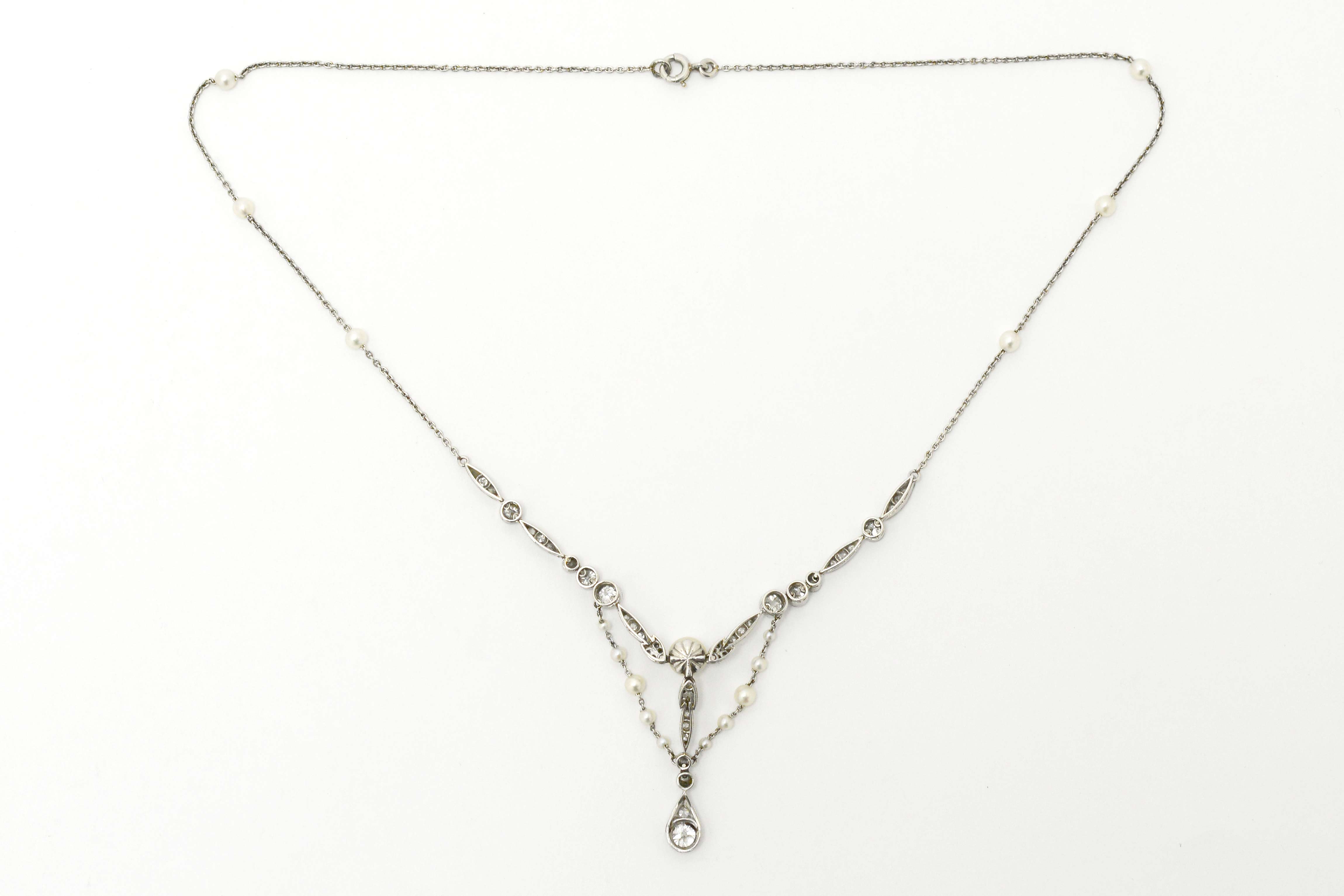 An early 1900s natural pearls and diamonds antique necklace.