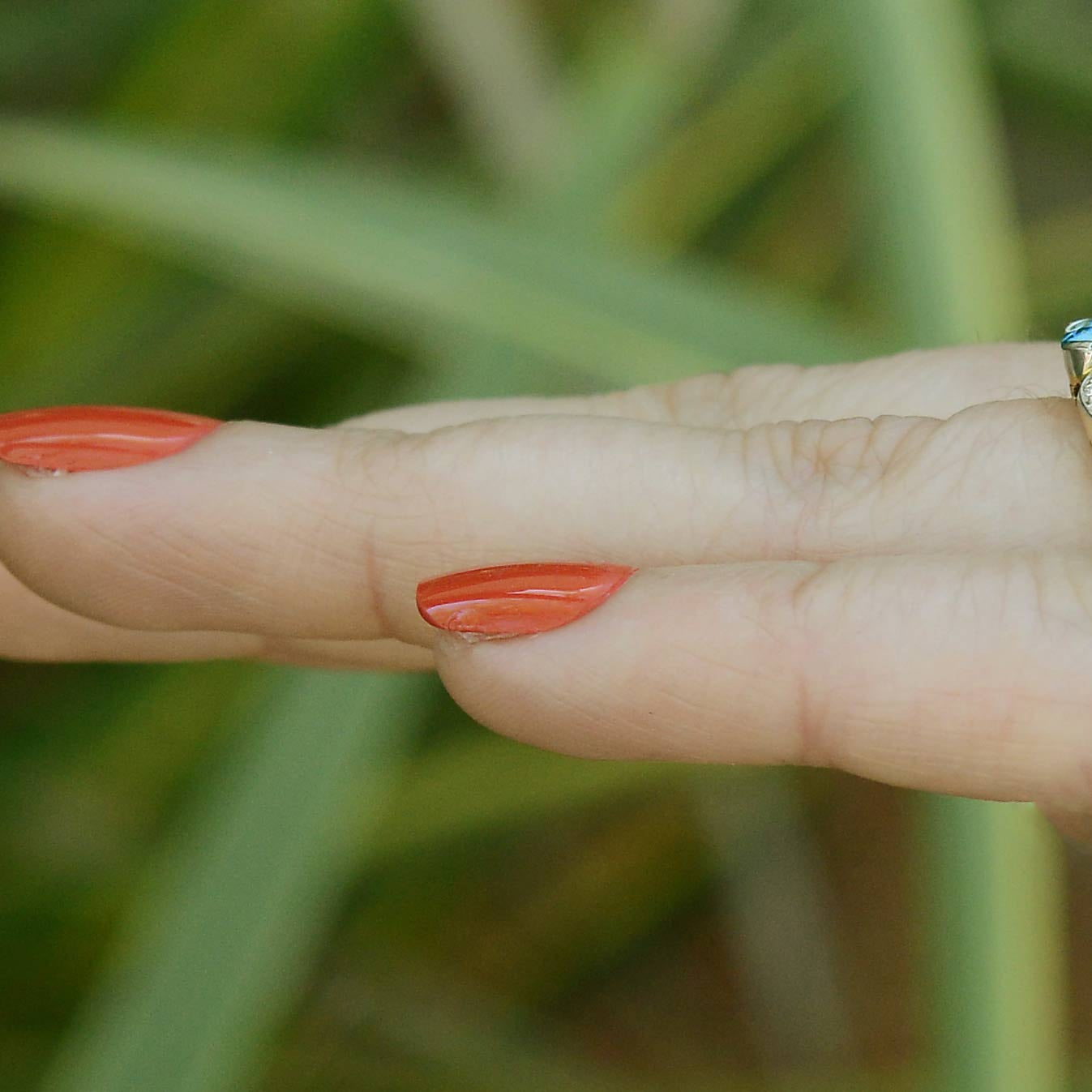 A nearly 3 carat round zircon ring with three diamonds to each side of the gem.
