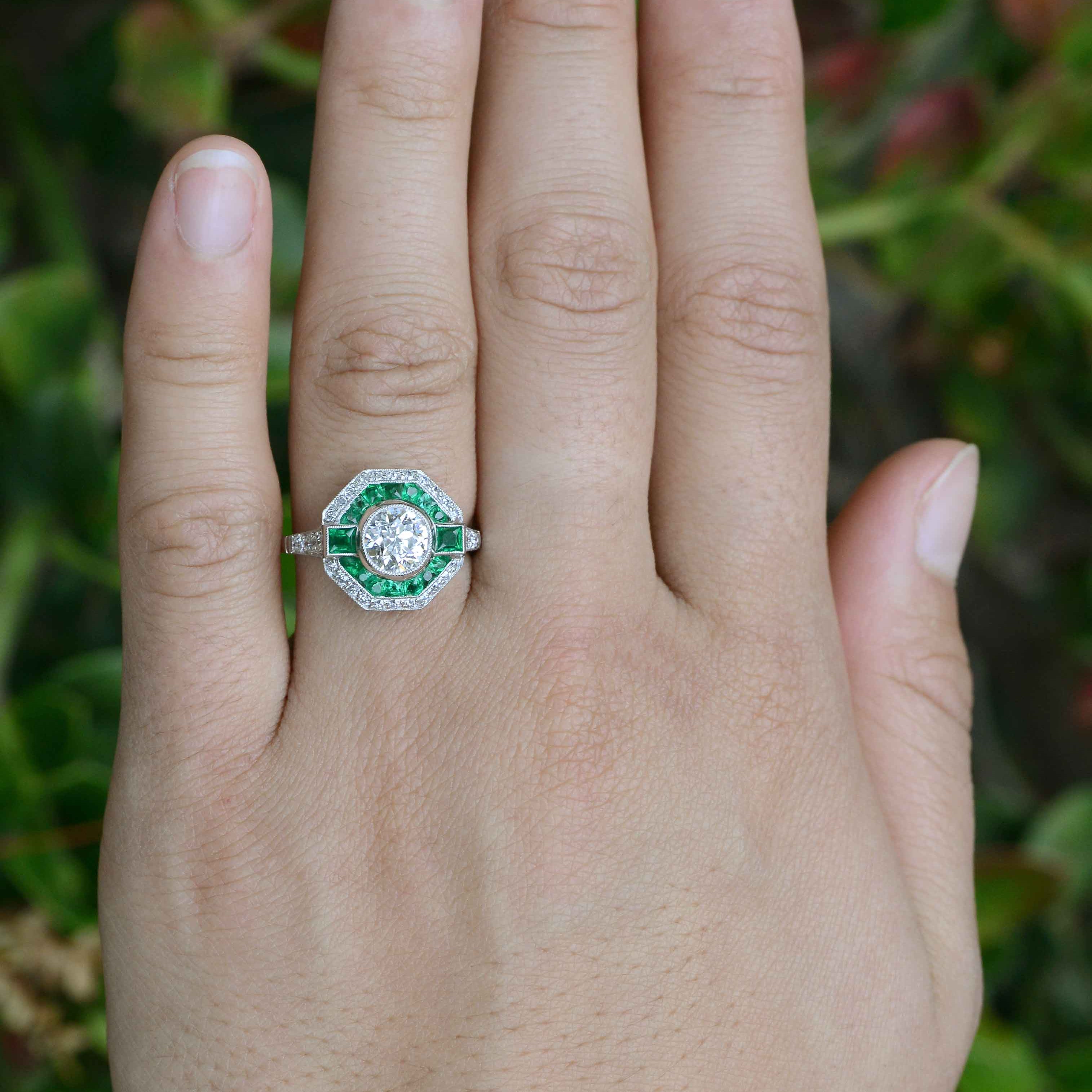 An octagon shape diamond wedding ring with an emerald halo.