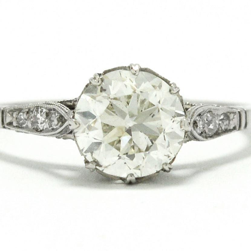 The center diamond in this Edwardian style solitaire ring is over one carat.
