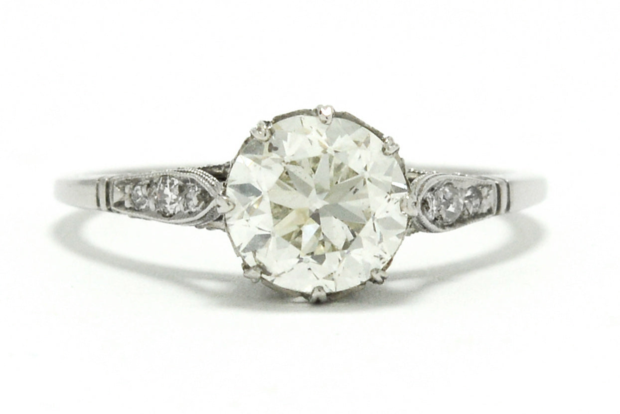 The center diamond in this Edwardian style solitaire ring is over one carat.