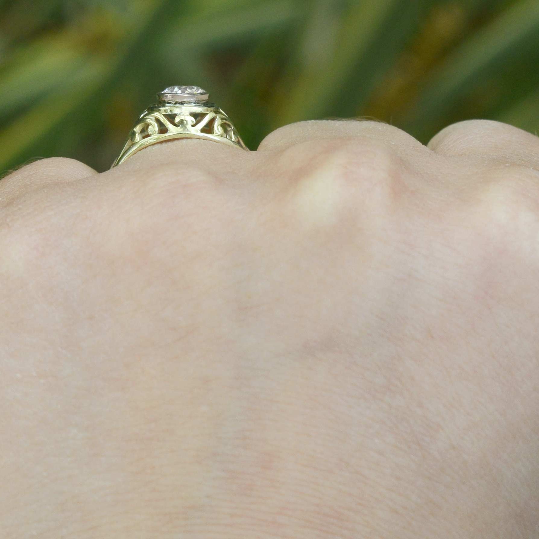 An i color and si2 clarity diamond set in unique filigree engagement ring.