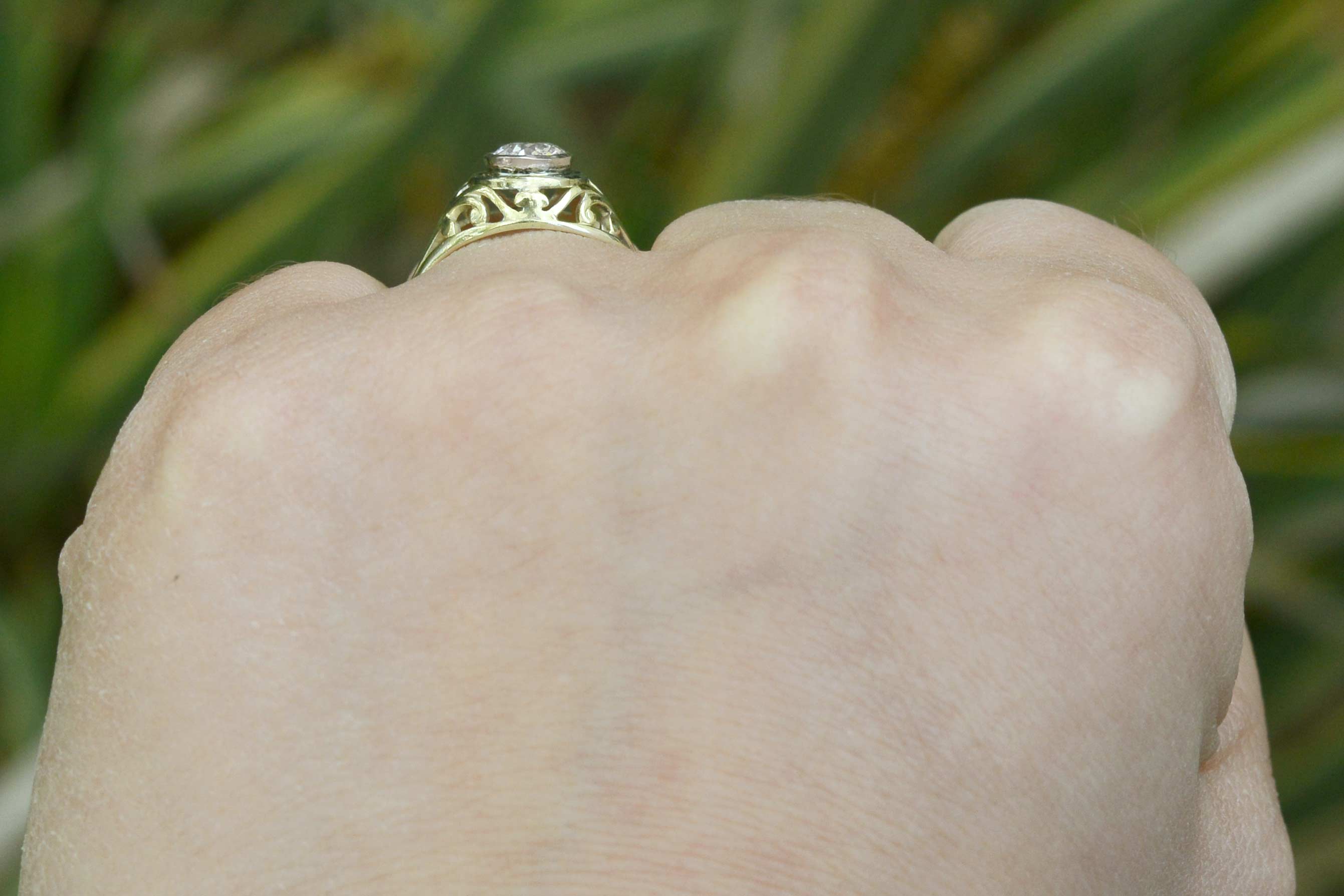 An i color and si2 clarity diamond set in unique filigree engagement ring.