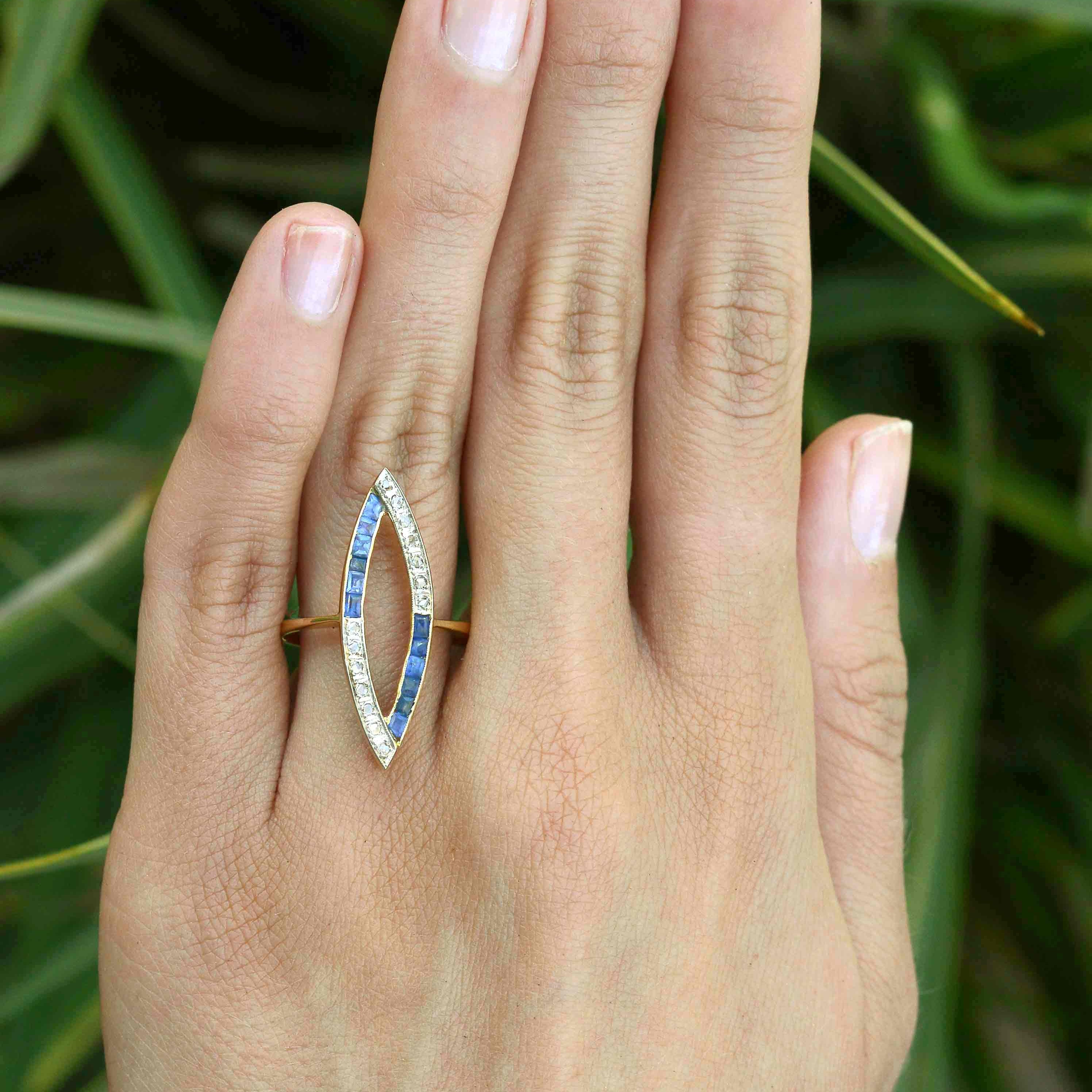 Rose cut diamonds and French blue sapphires line this open work navette ring.