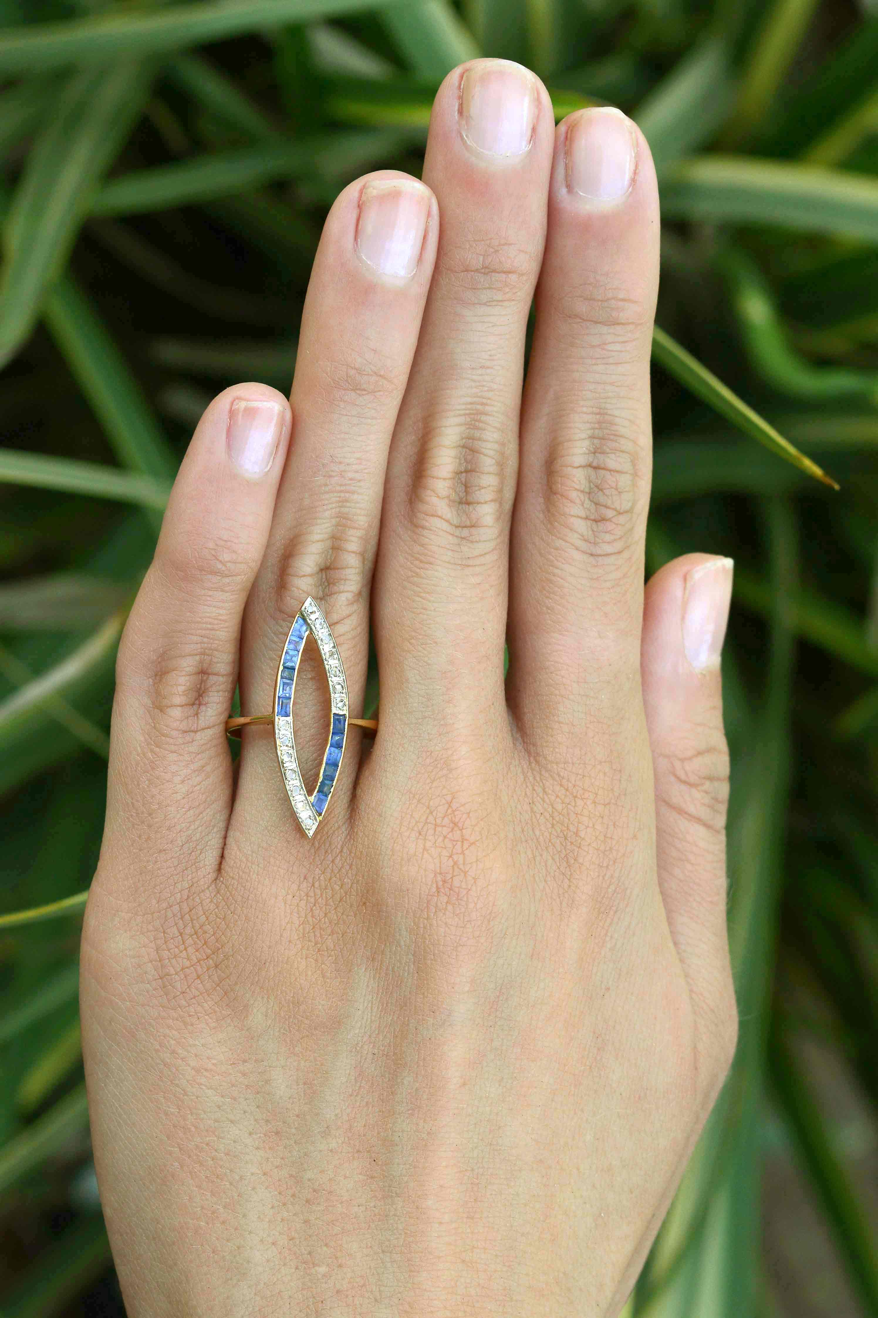 Rose cut diamonds and French blue sapphires line this open work navette ring.