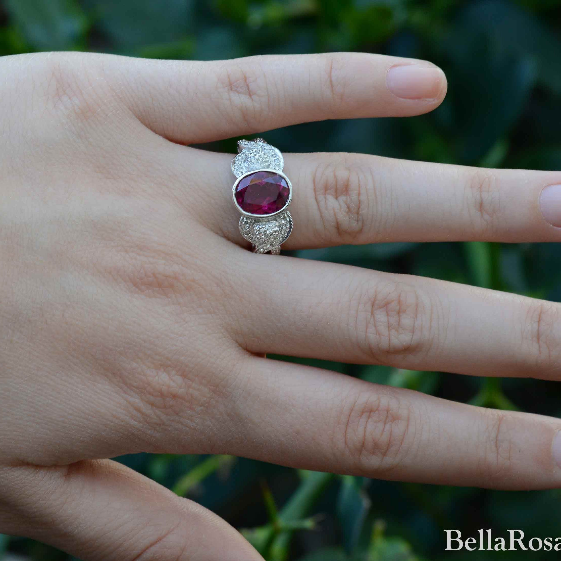 A retro purple red oval tourmaline engagement ring.