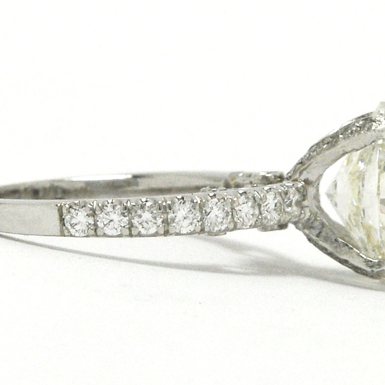 Diamonds are on the straight band of this solitaire wedding ring.