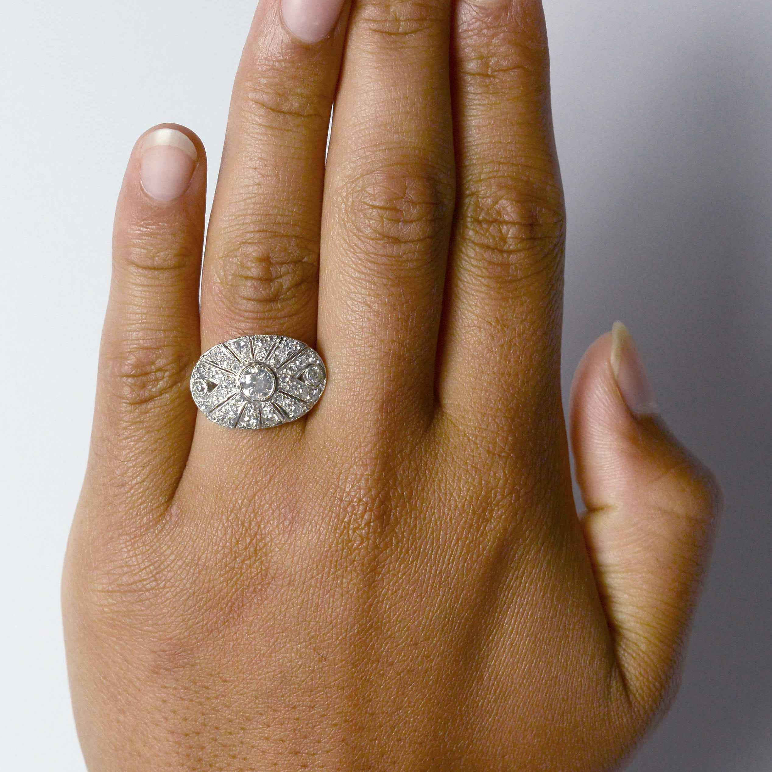 A third carat round brilliant diamond, oval shaped statement ring.