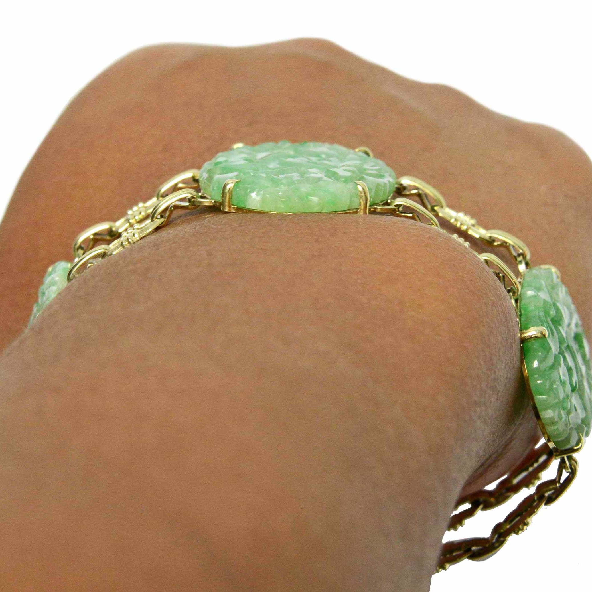 An antique, low profile oval jade and gold link bracelet.