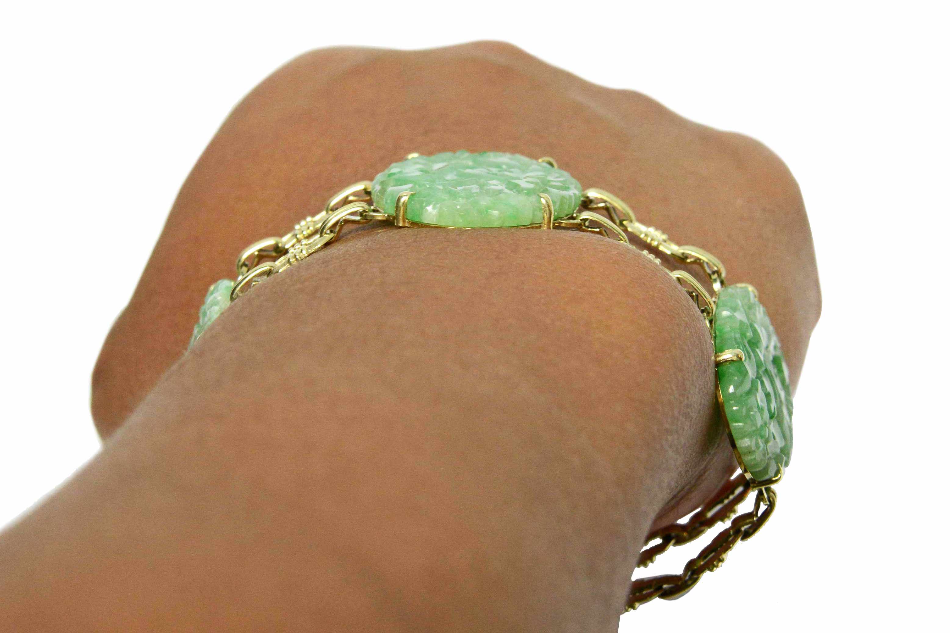 An antique, low profile oval jade and gold link bracelet.