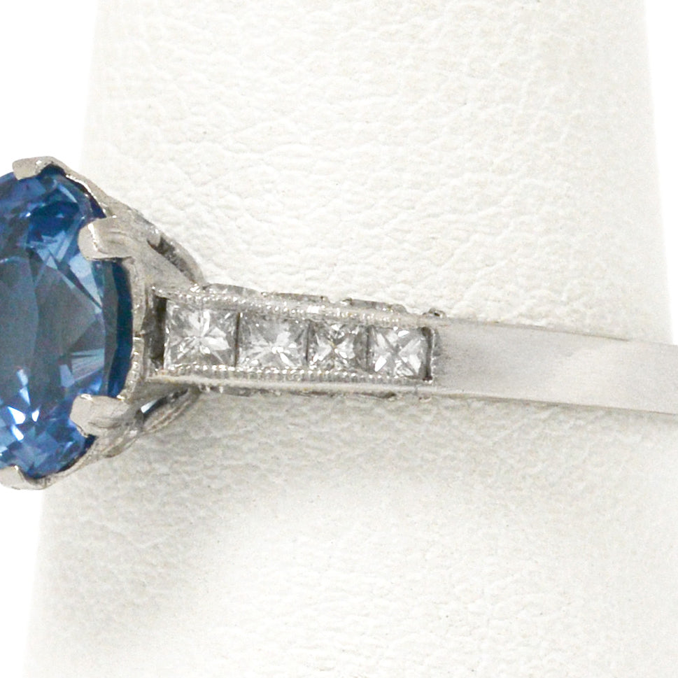 8 diamonds support the ceylon blue sapphire in this platinum vintage engagement ring.