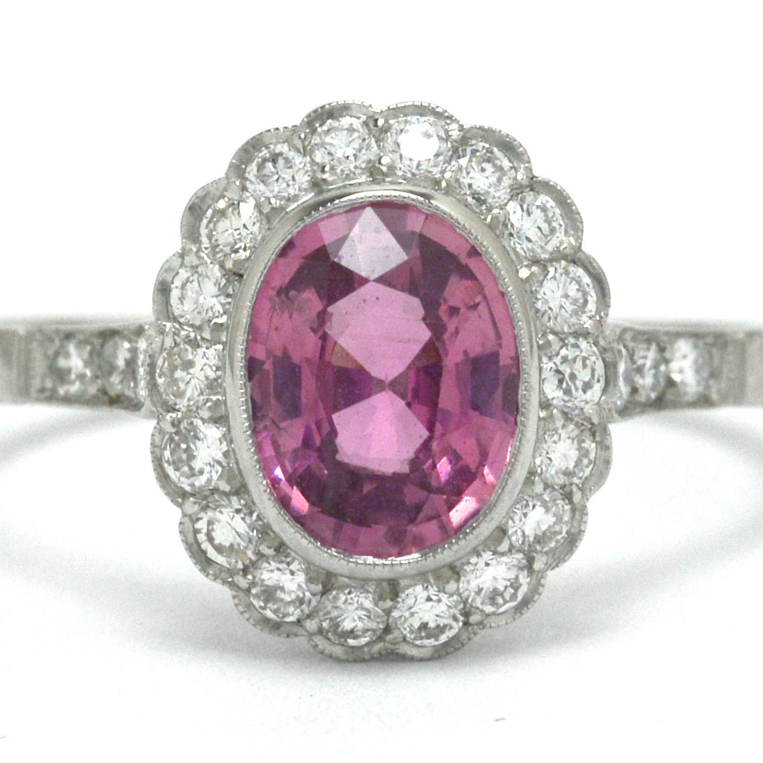 Art Deco style oval pink sapphire diamond halo engagement ring.