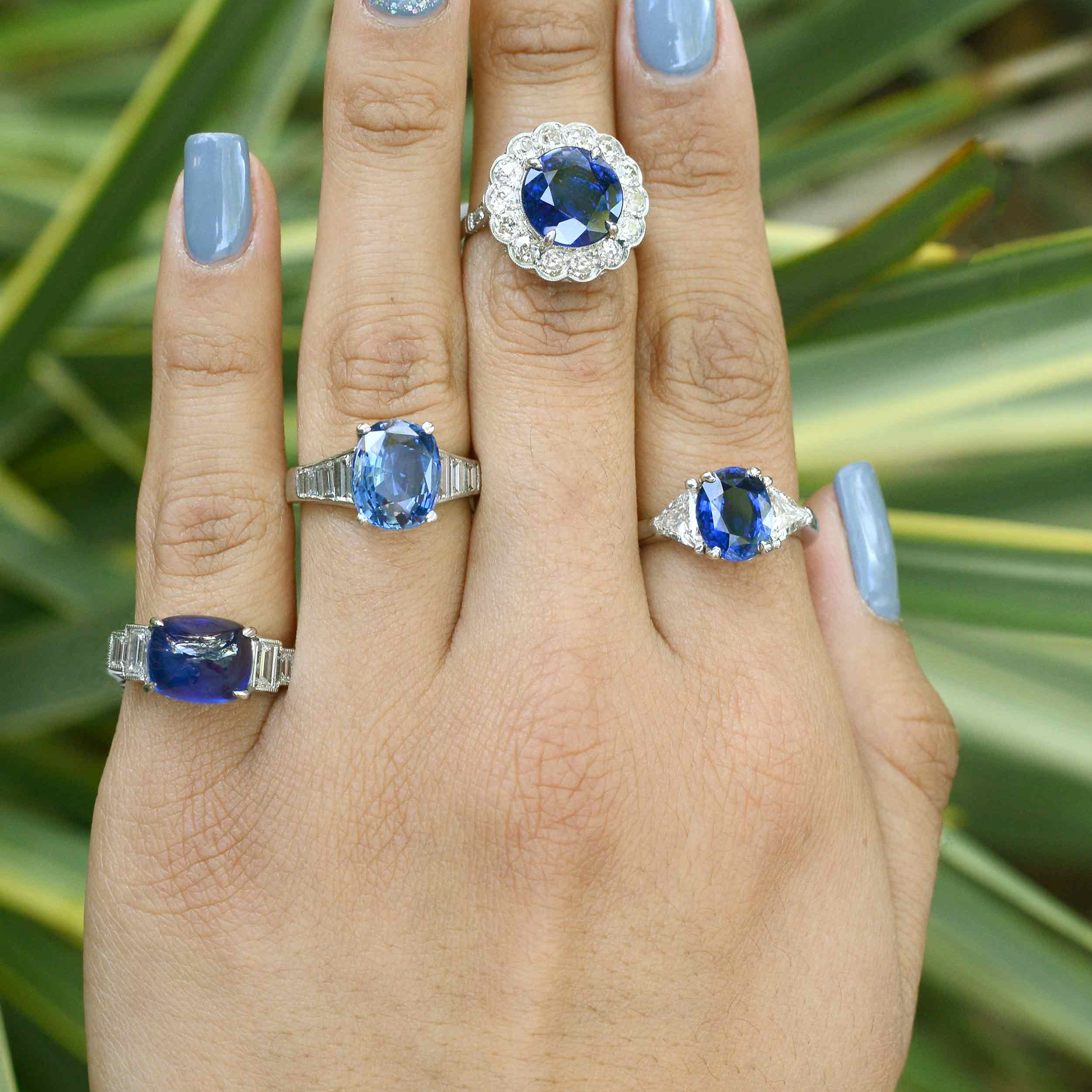A collection of large blue sapphire and diamond engagement rings.