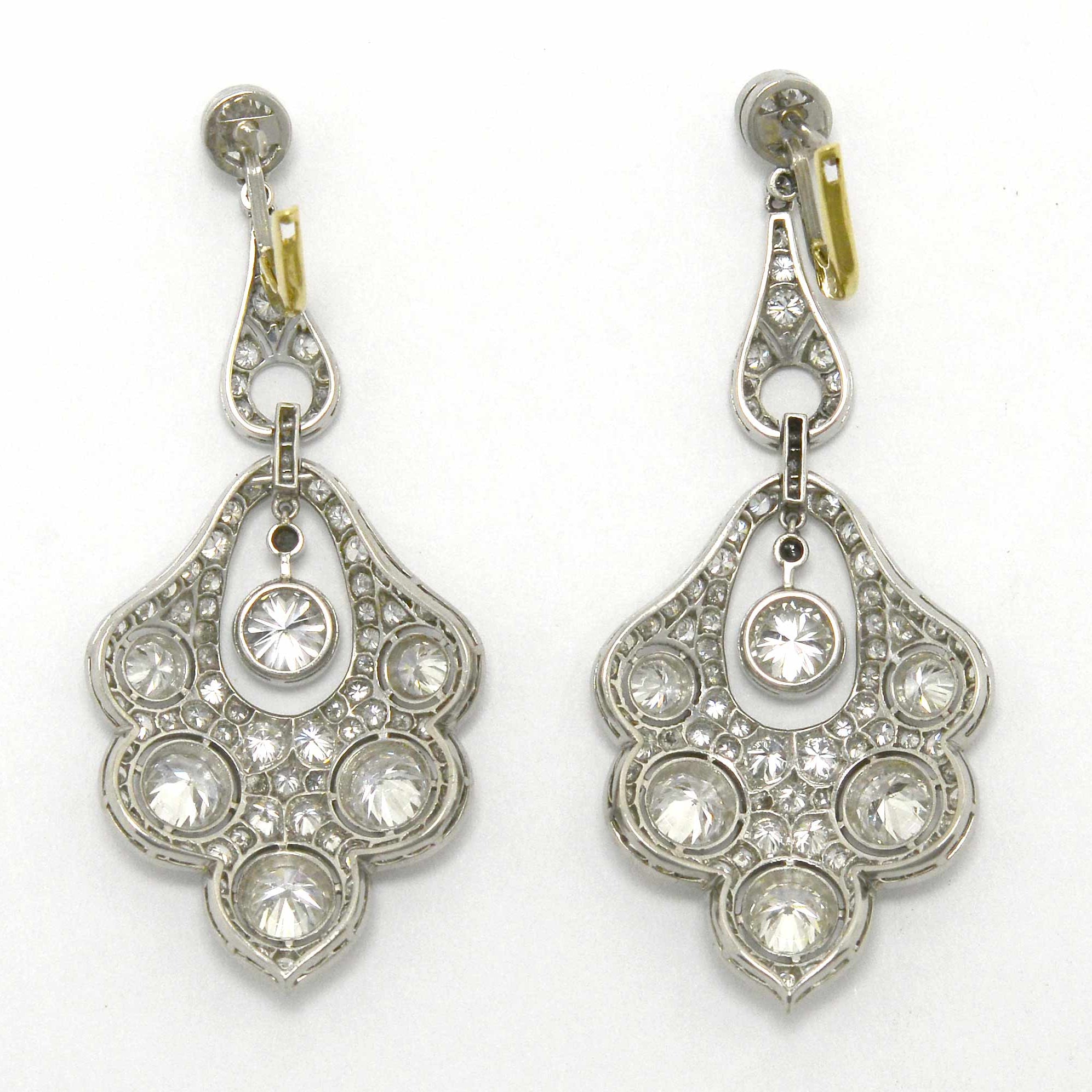 Gold lever and platinum peacock feather diamond earrings.