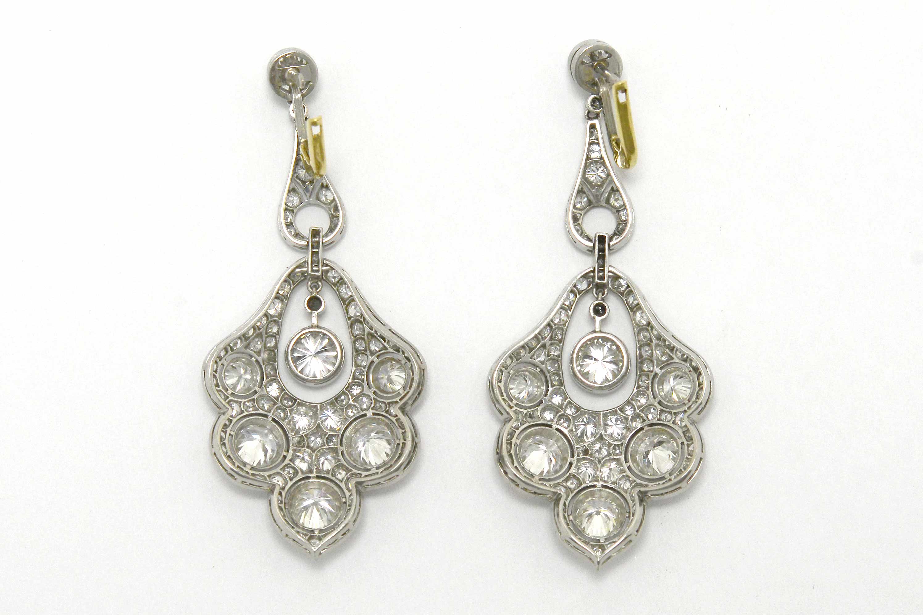 Gold lever and platinum peacock feather diamond earrings.