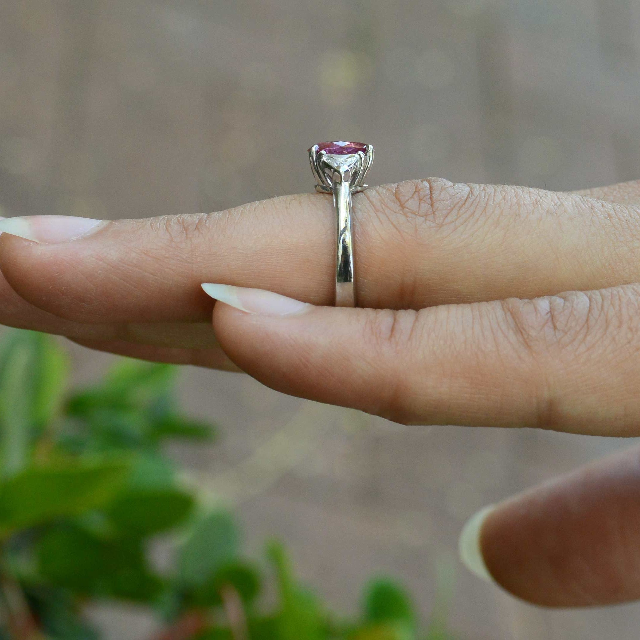 A 3 stone, wedding ring trinity design with a natural pink sapphire and diamonds.