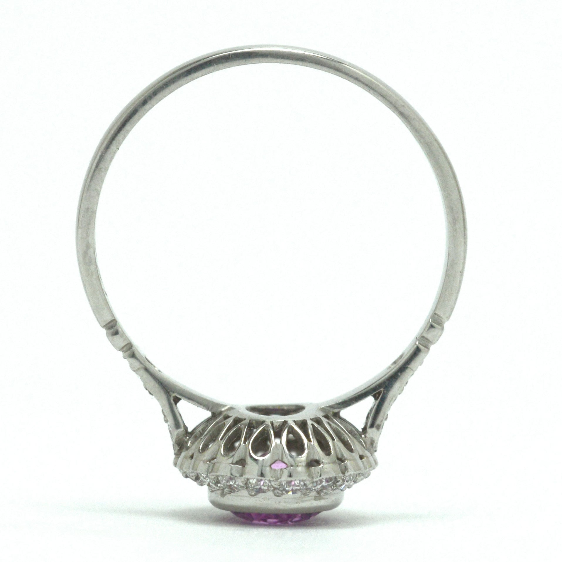 A platinum foliate scrolled under-crown engagement ring.