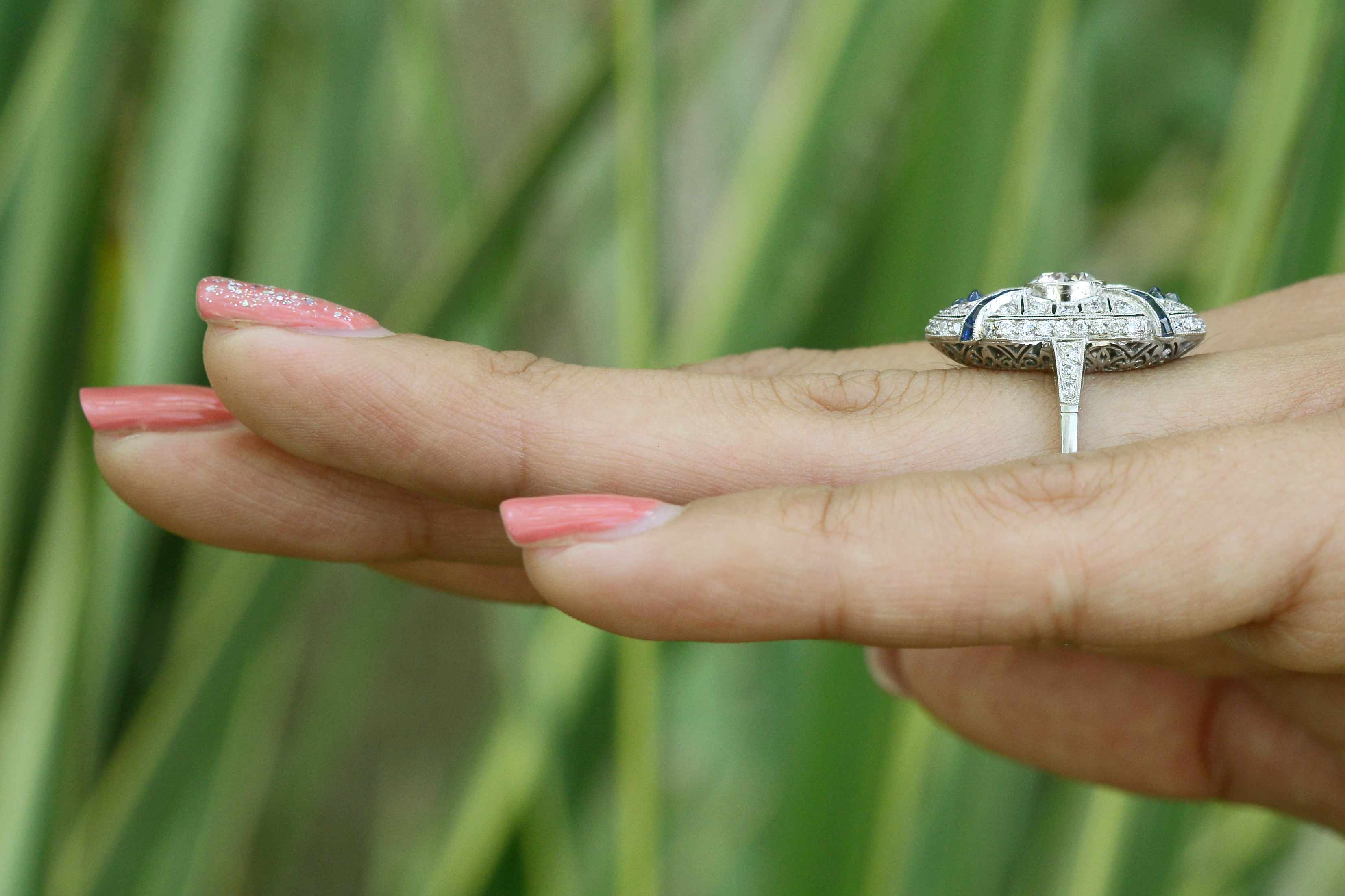 A long platinum cocktail ring with a transitional round brilliant diamond.