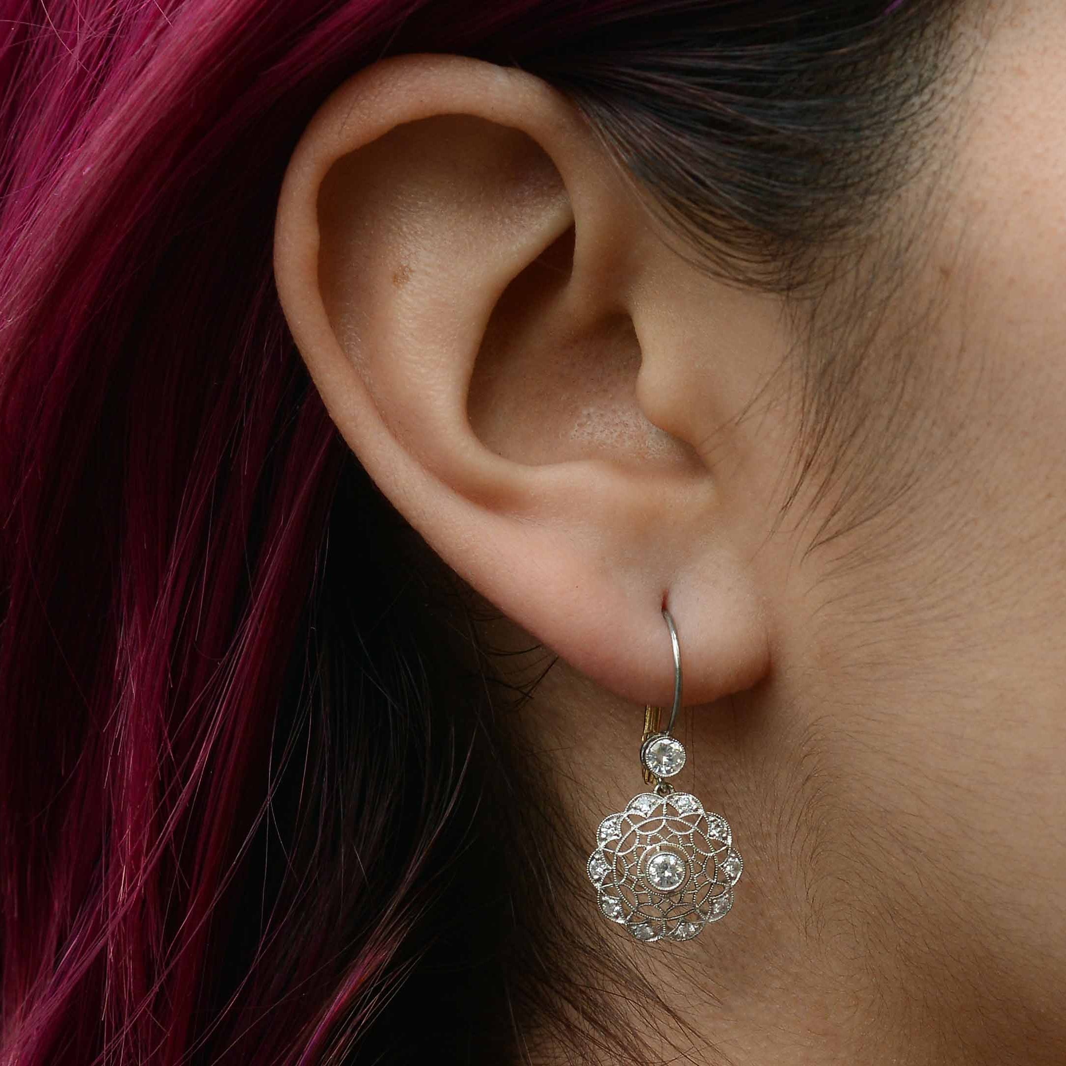 These diamond cluster earrings resemble a spider web.