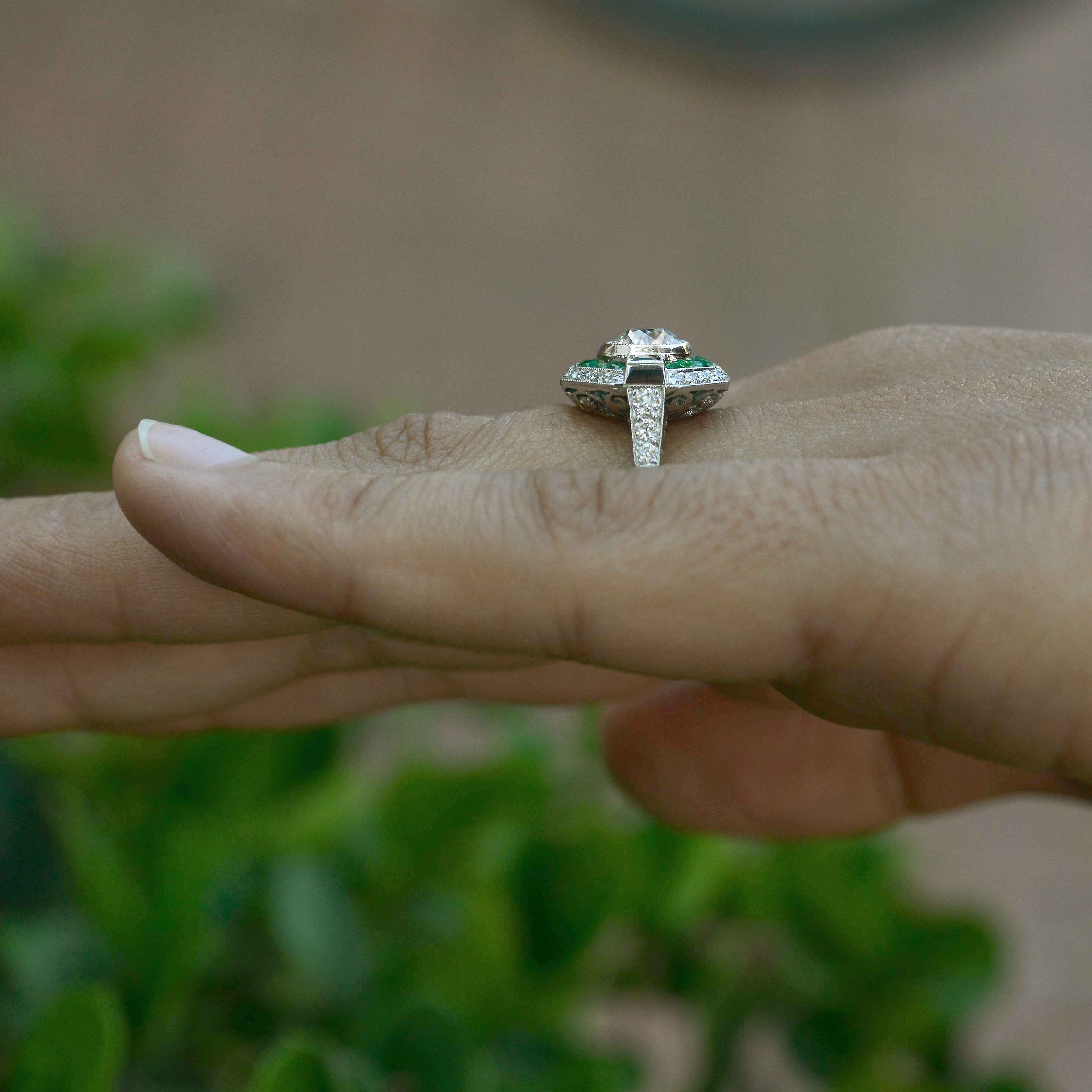 A unique geometric diamond emerald halo pattern wedding ring.
