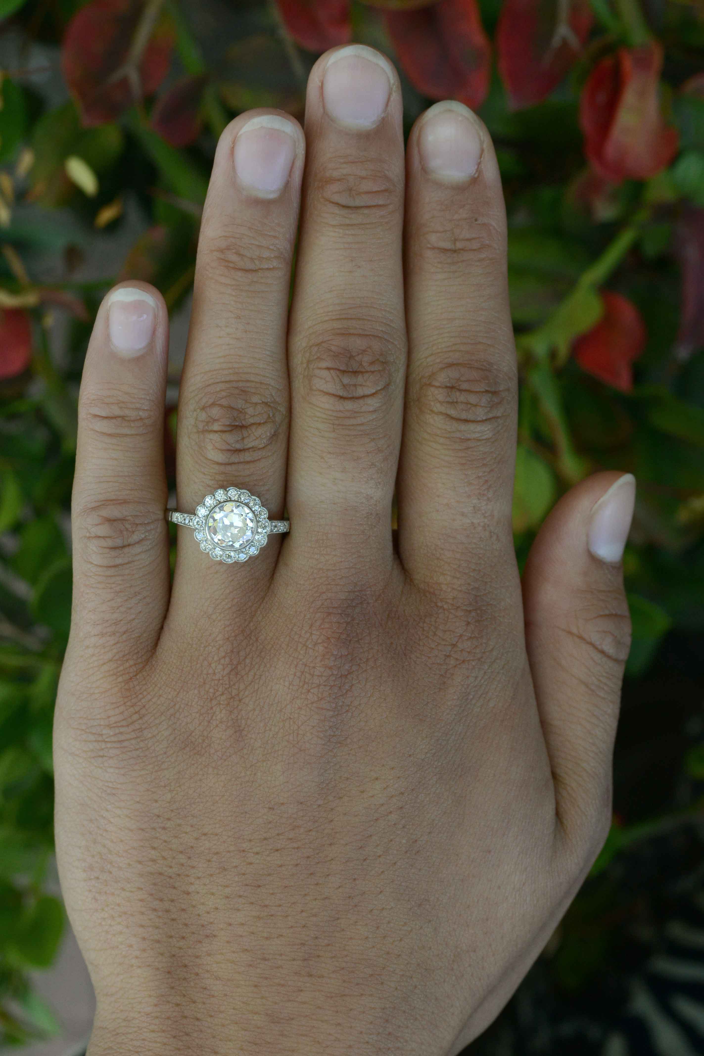Old European diamond flower petal cluster engagement ring.