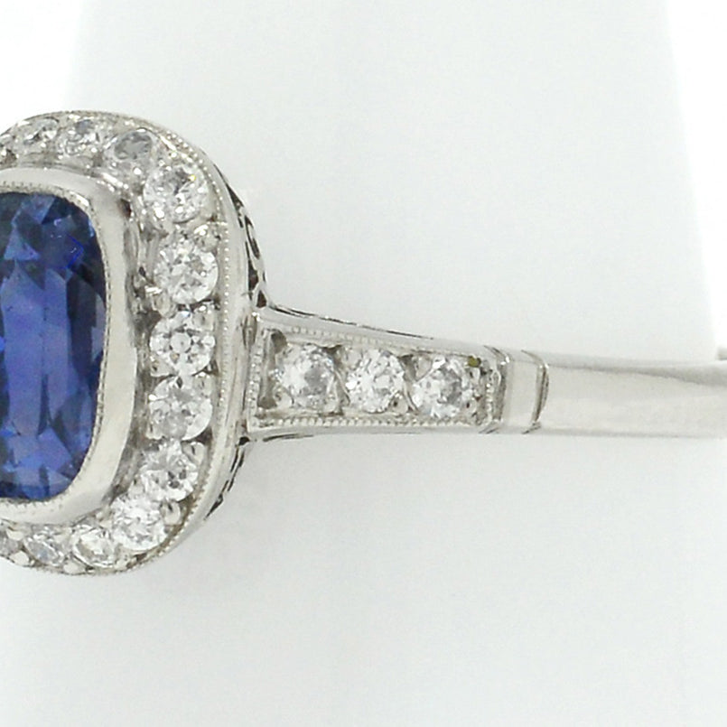 Old European diamonds line the 3 carat unheated sapphire in this halo engagement ring.