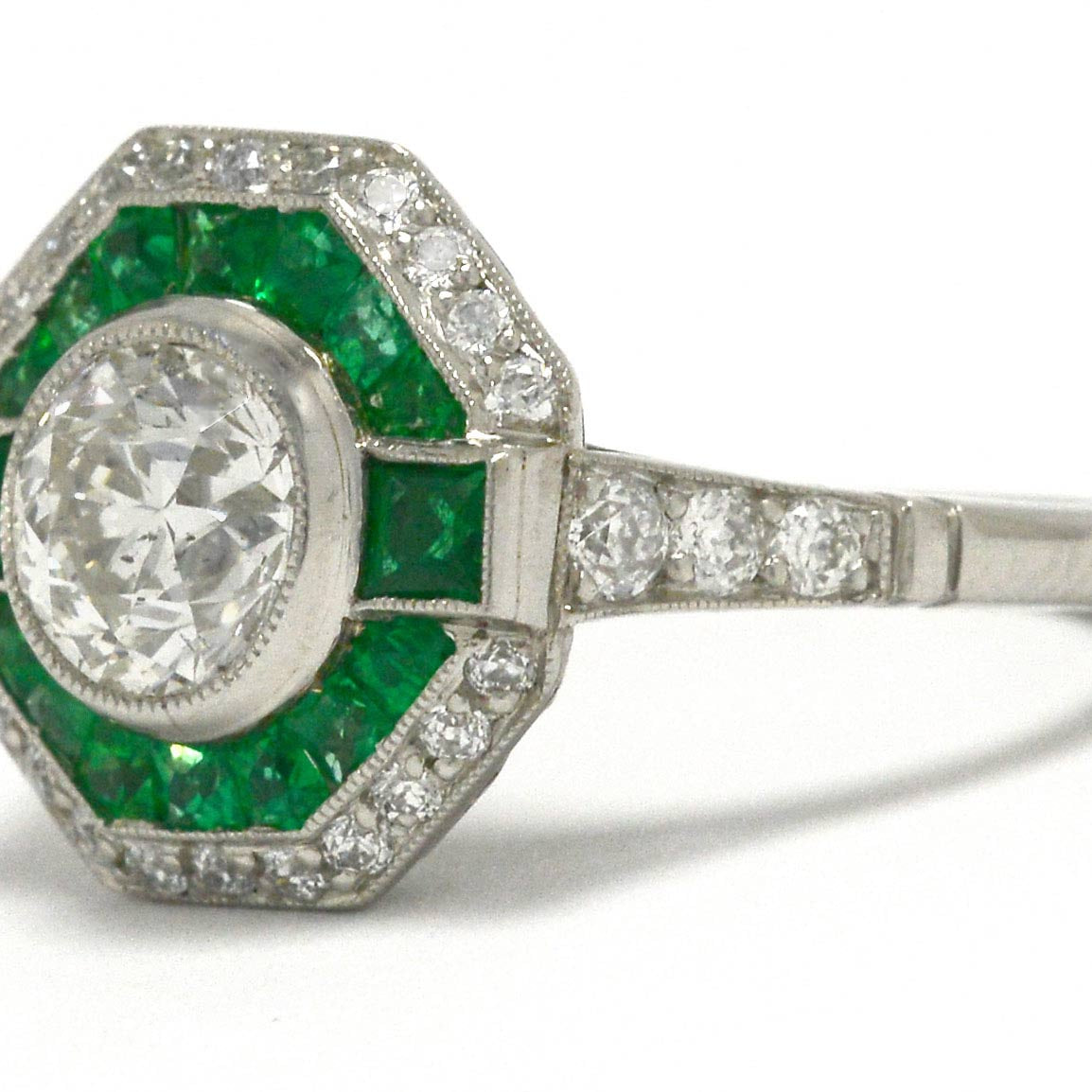A transitional round brilliant diamond emerald halo octagon engaggement ring.