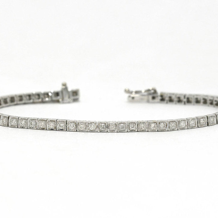 Two carats of straight line set diamonds in a 1940s white gold tennis bracelet.