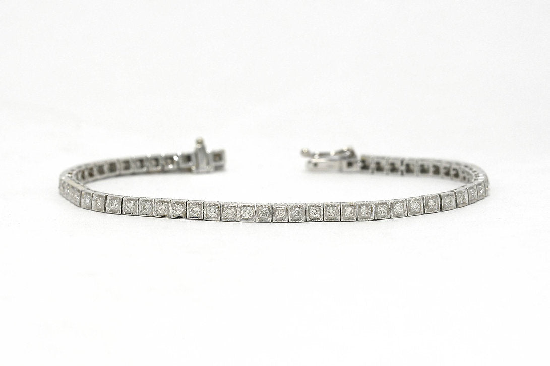 Two carats of straight line set diamonds in a 1940s white gold tennis bracelet.