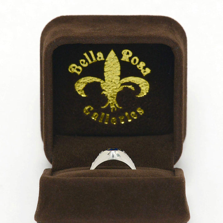 A platinum, dome setting sapphire ring with 6 diamonds.