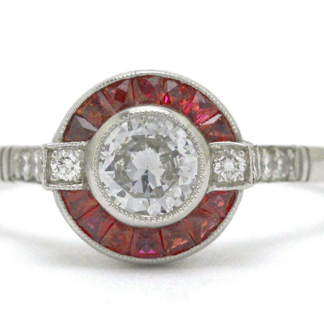 An Art Deco diamond ruby arch, halo engagement ring.