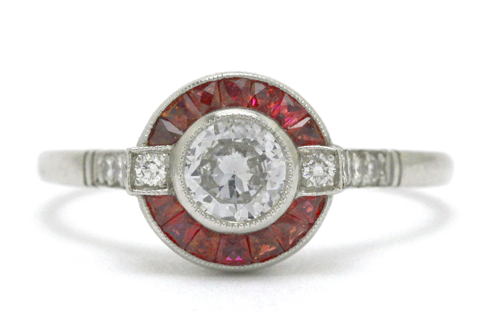 An Art Deco diamond ruby arch, halo engagement ring.
