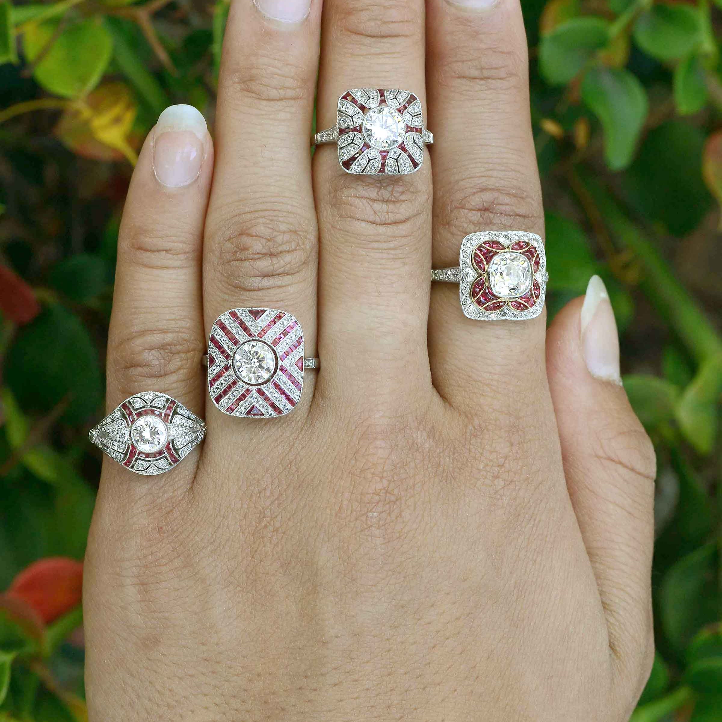 A collection of diamond with ruby accent, platinum engagement rings.