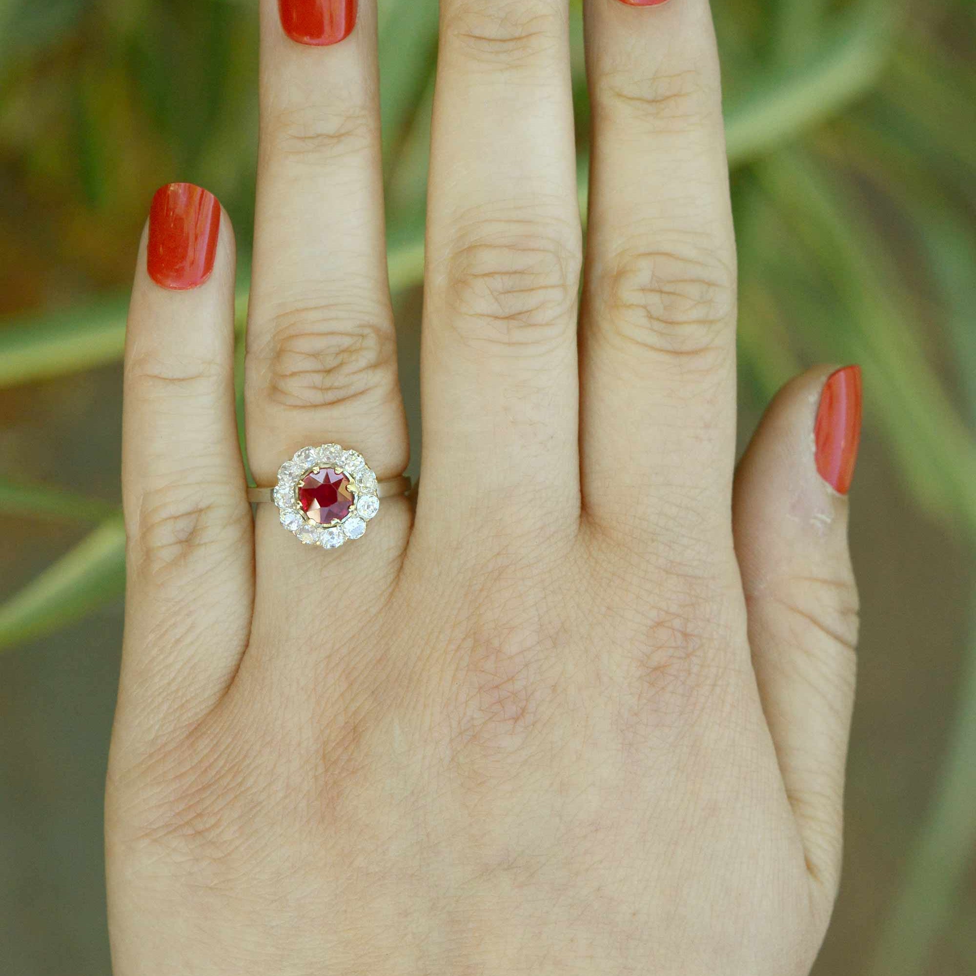 A unique size 5 platinum ruby engagement ring with an 18k gold center setting.