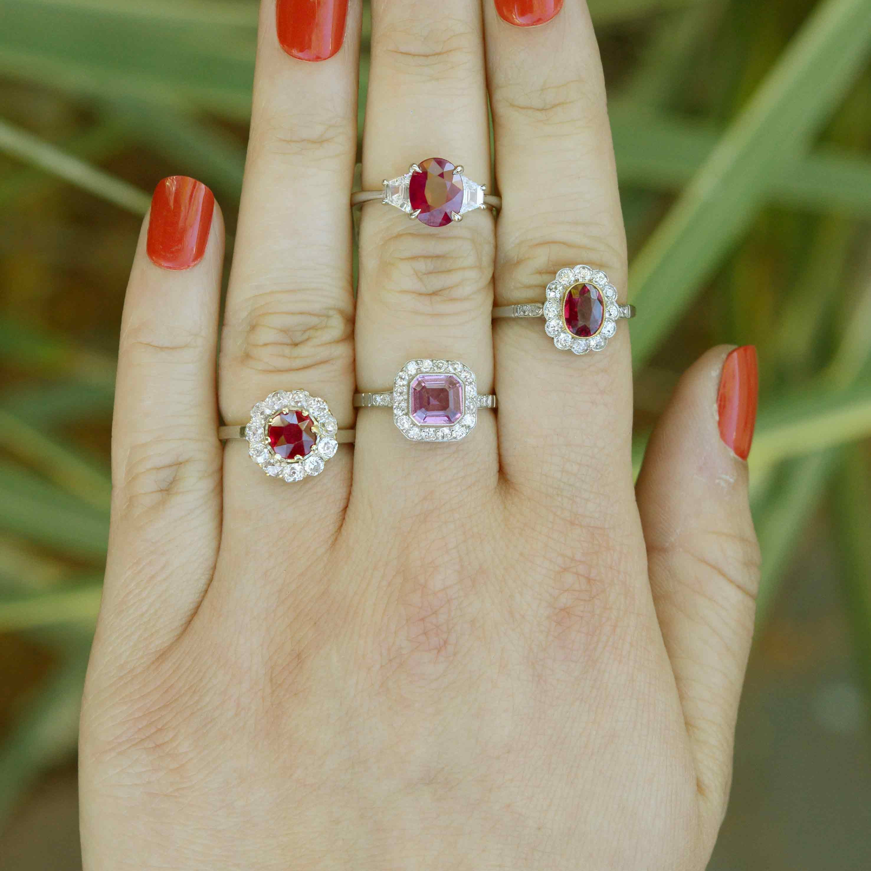 Bright red ruby engagement rings, as well as one with a bright pink sapphire.