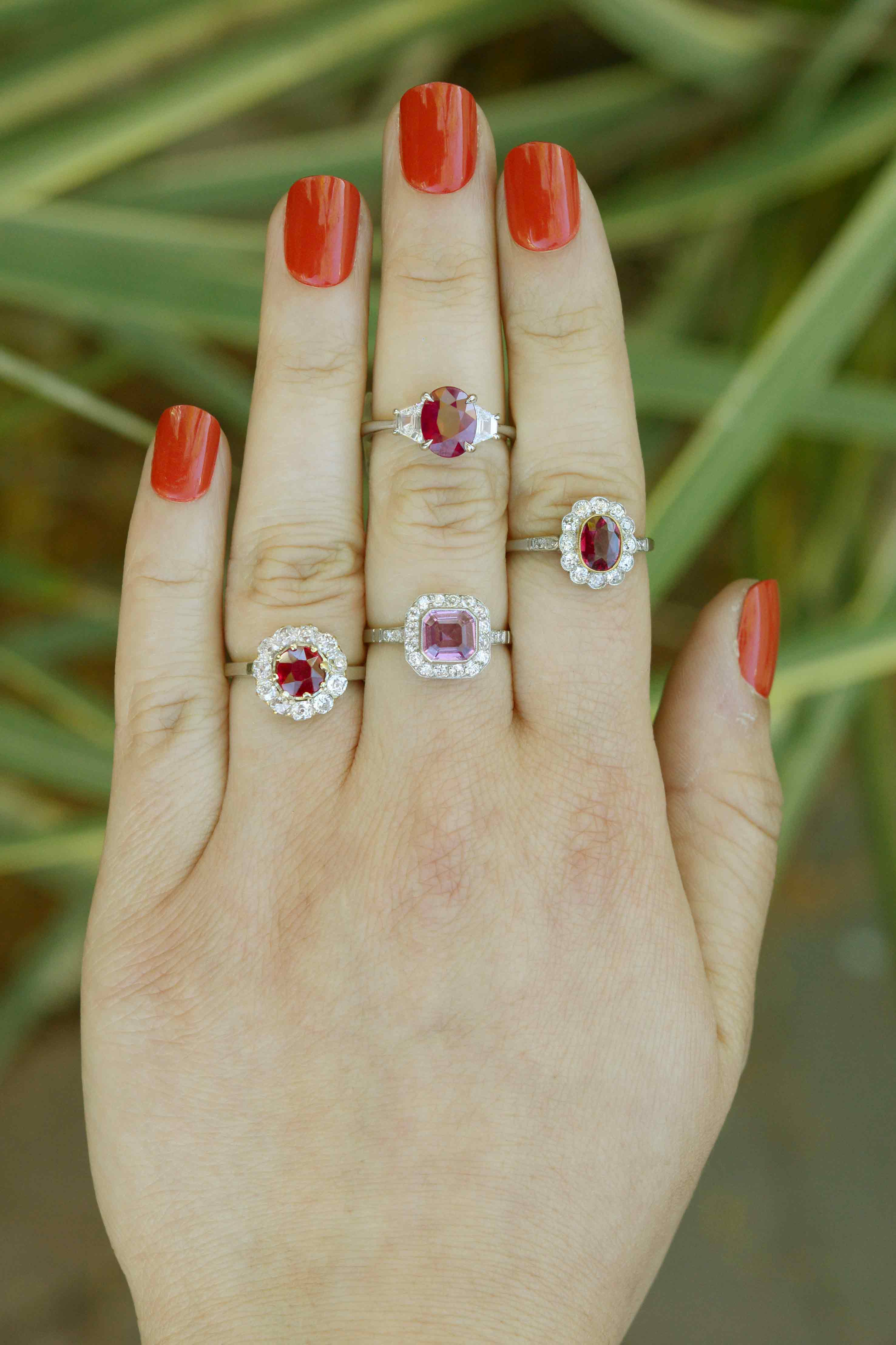 Bright red ruby engagement rings, as well as one with a bright pink sapphire.