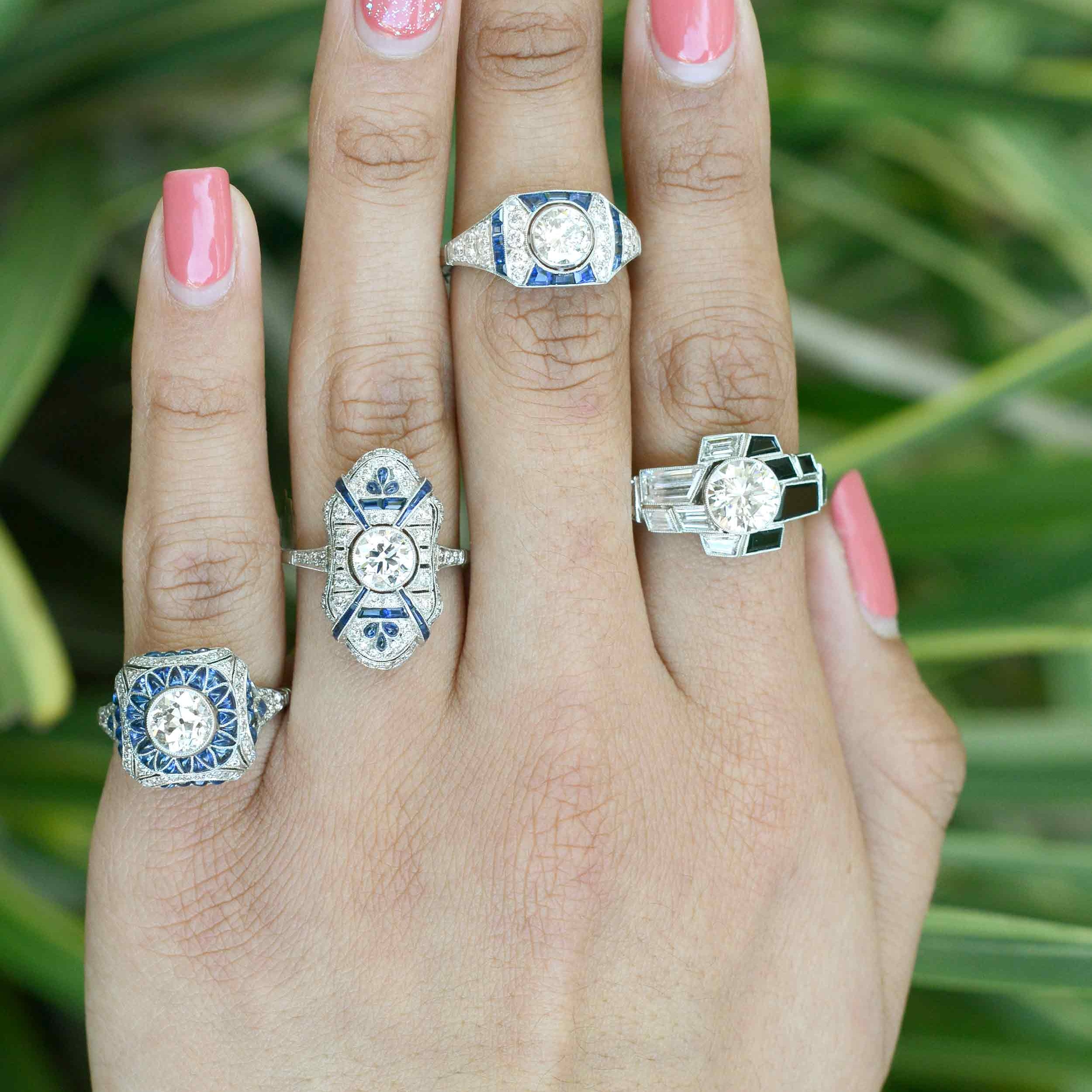 A collection of diamond and sapphire Art Deco wedding rings.