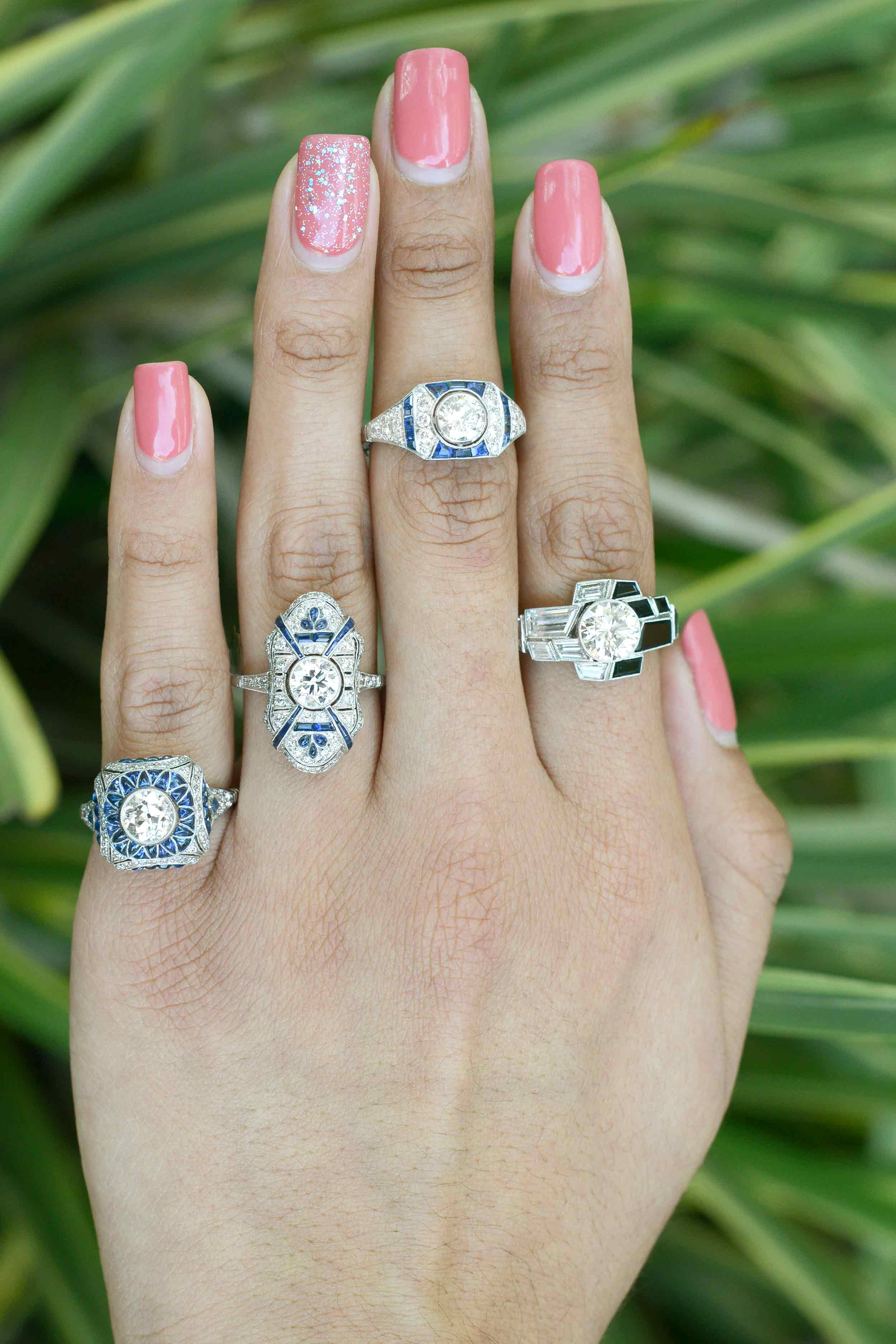 A collection of diamond and sapphire Art Deco wedding rings.