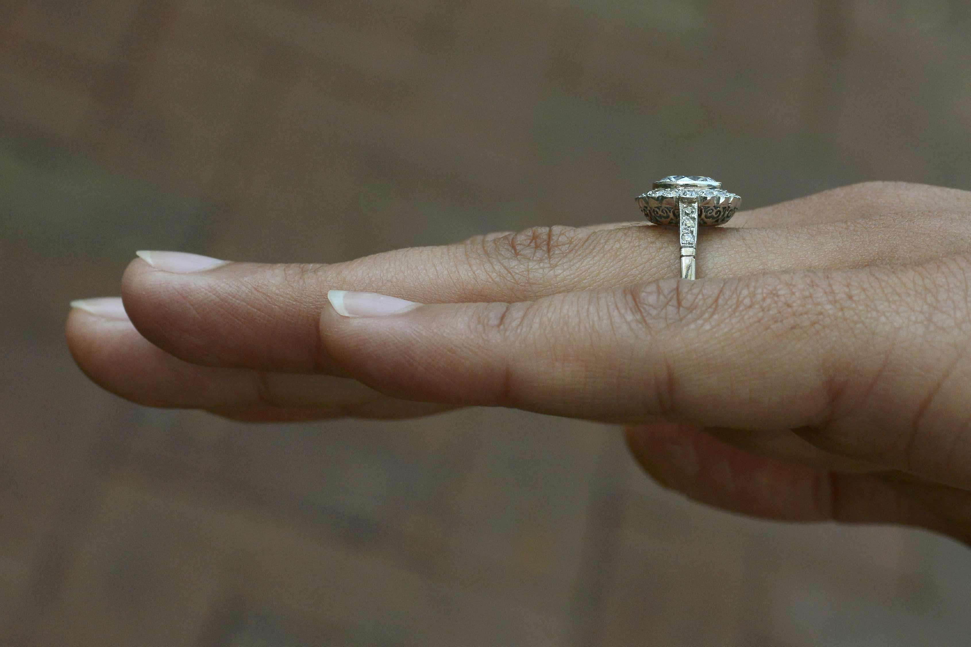 A durable floral diamond halo engagement ring.