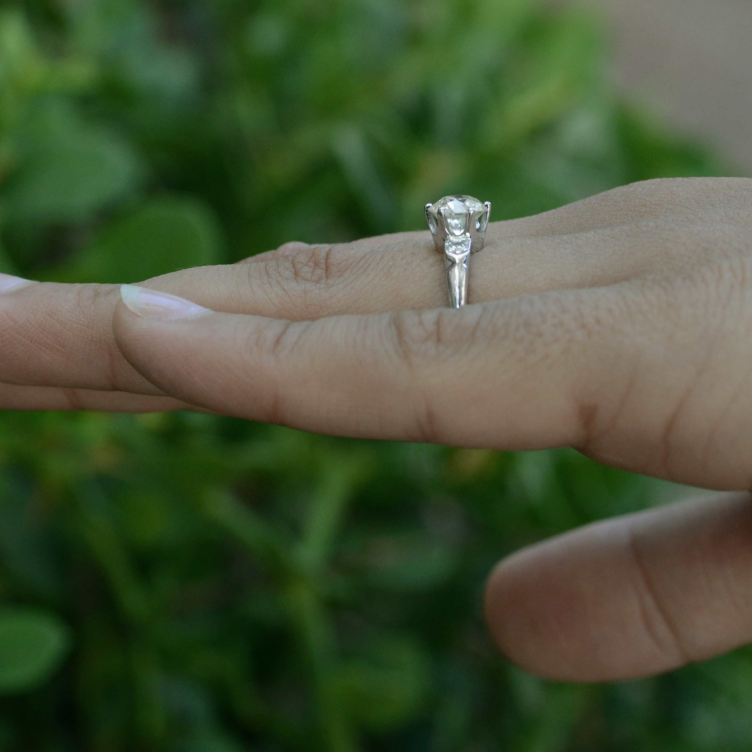 This Art Deco diamond solitaire has accent stones.