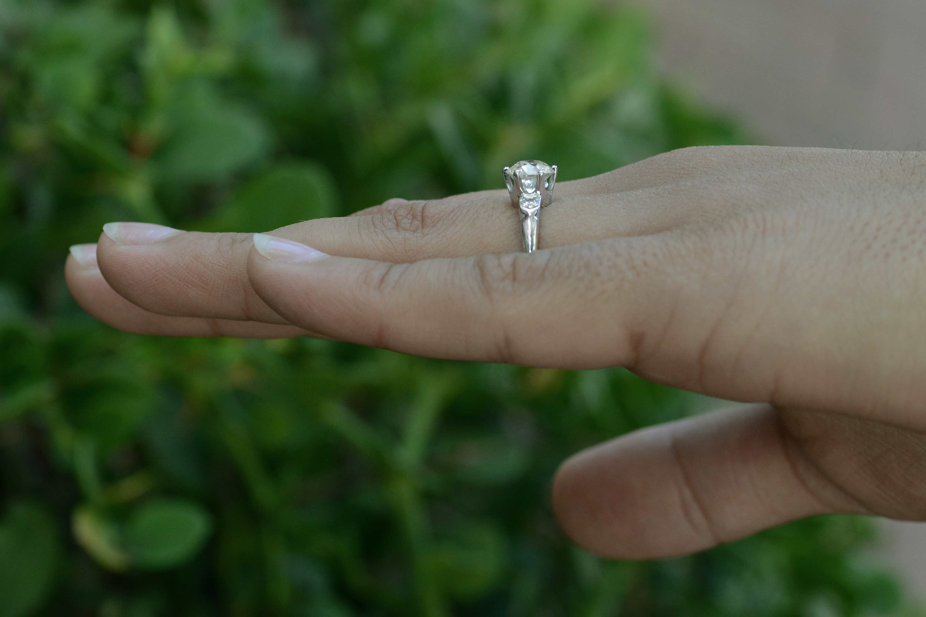 This Art Deco diamond solitaire has accent stones.
